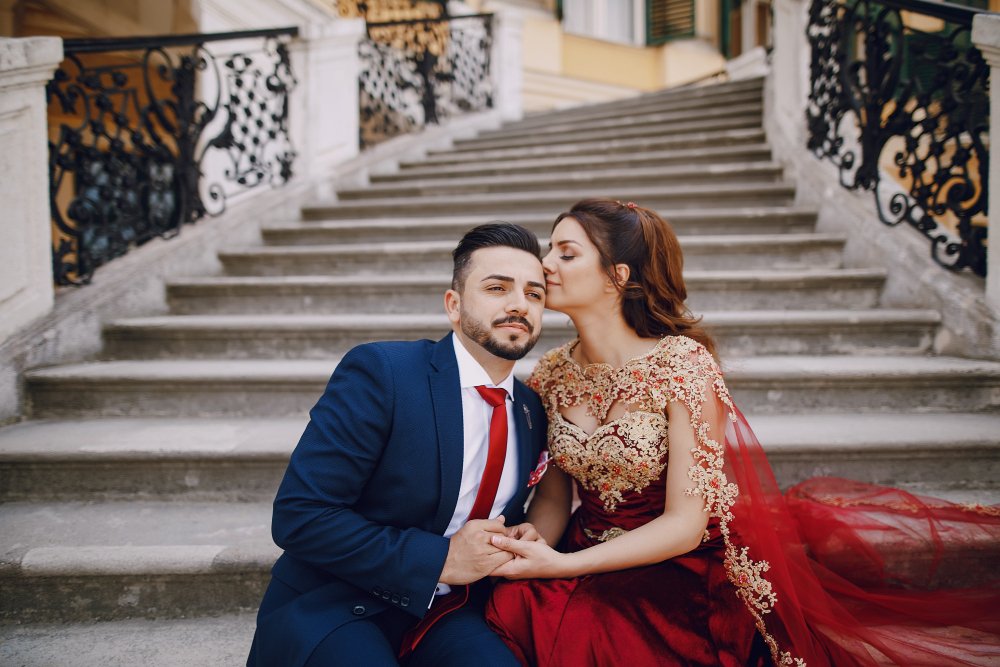 Kabir and Dia on stone steps, a kiss on the cheek